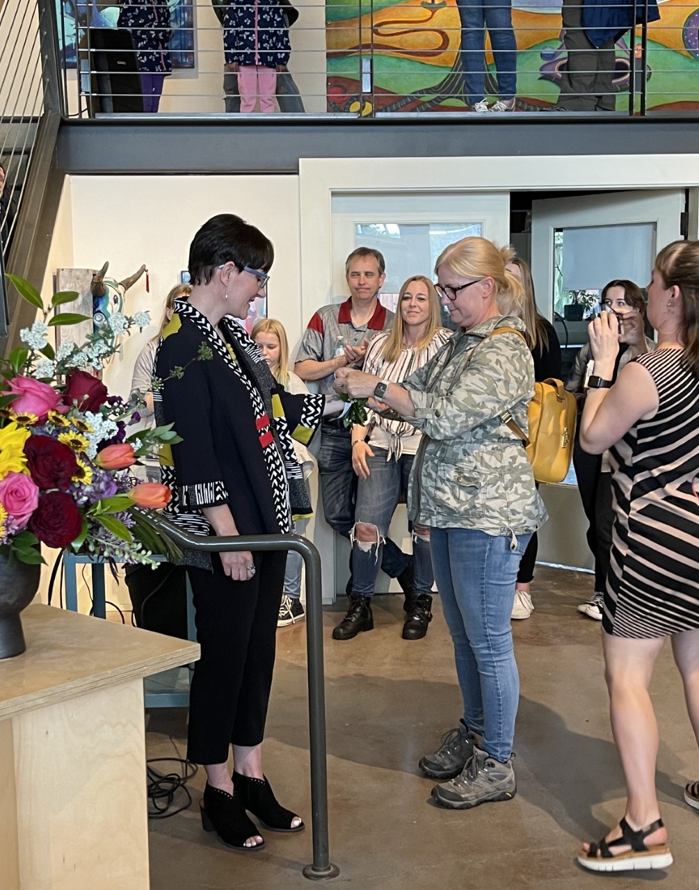 Ellensburg Poet Laureate Marie Marchand receives a laurel wreath from Arts Commissioner Cassandra Town at an installment ceremony at Gallery One on June 2, 2022. Photo by Steve Van Ausdall.