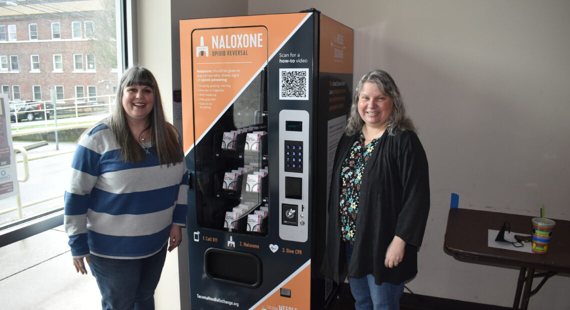 Rachel Ahrens and Nora Hacker of First United Methodist Church in downtown Tacoma, show off the building's new Narcan vending machine. The medicine inside is free to all and has already saved one person's life, that they know of. Photo by Lauren Gallup.