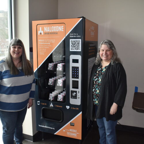 Rachel Ahrens and Nora Hacker of First United Methodist Church in downtown Tacoma, show off the building's new Narcan vending machine. The medicine inside is free to all and has already saved one person's life, that they know of. Photo by Lauren Gallup.