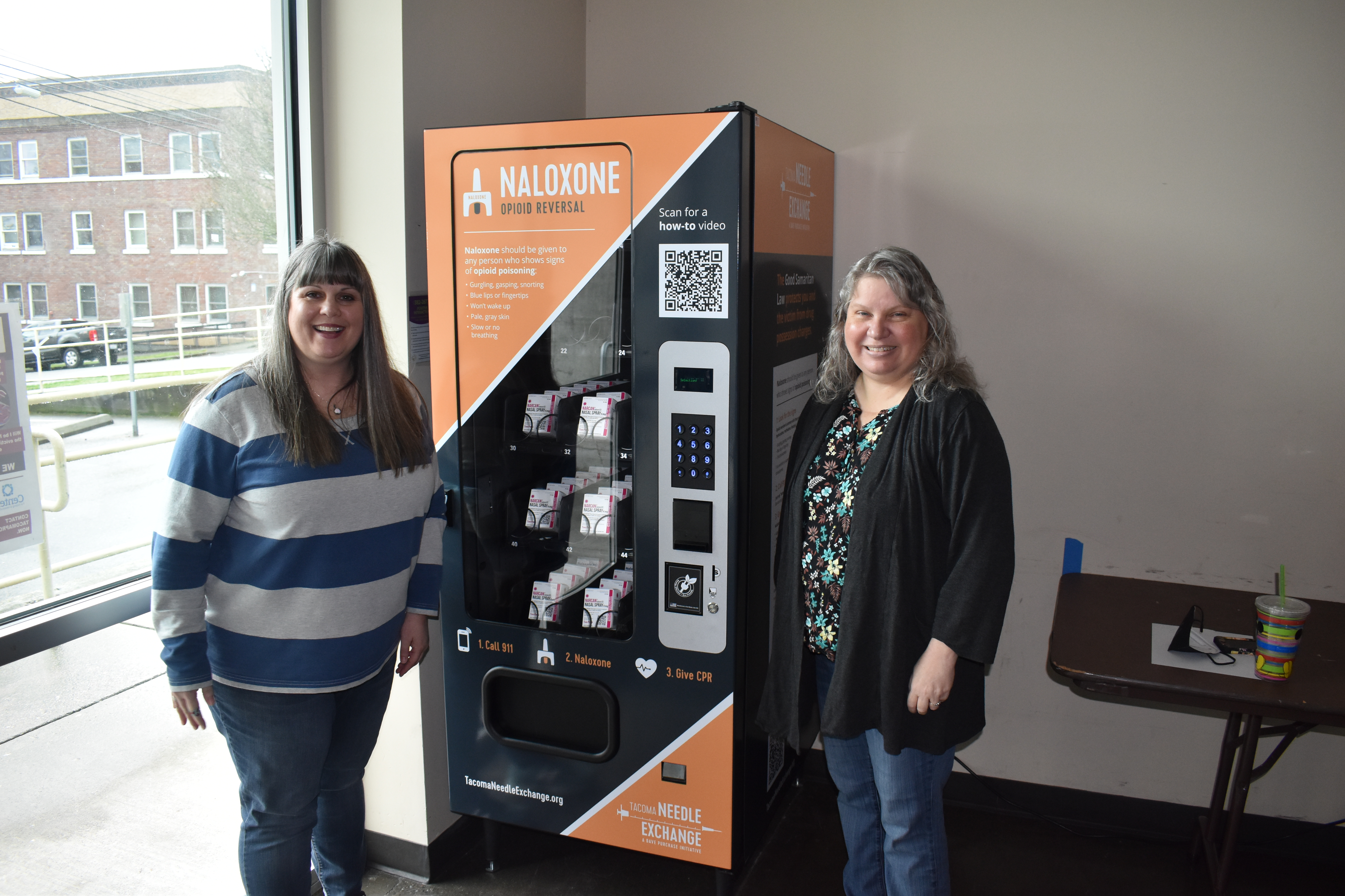Rachel Ahrens and Nora Hacker of First United Methodist Church in downtown Tacoma, show off the building's new Narcan vending machine. The medicine inside is free to all and has already saved one person's life, that they know of. Photo by Lauren Gallup.