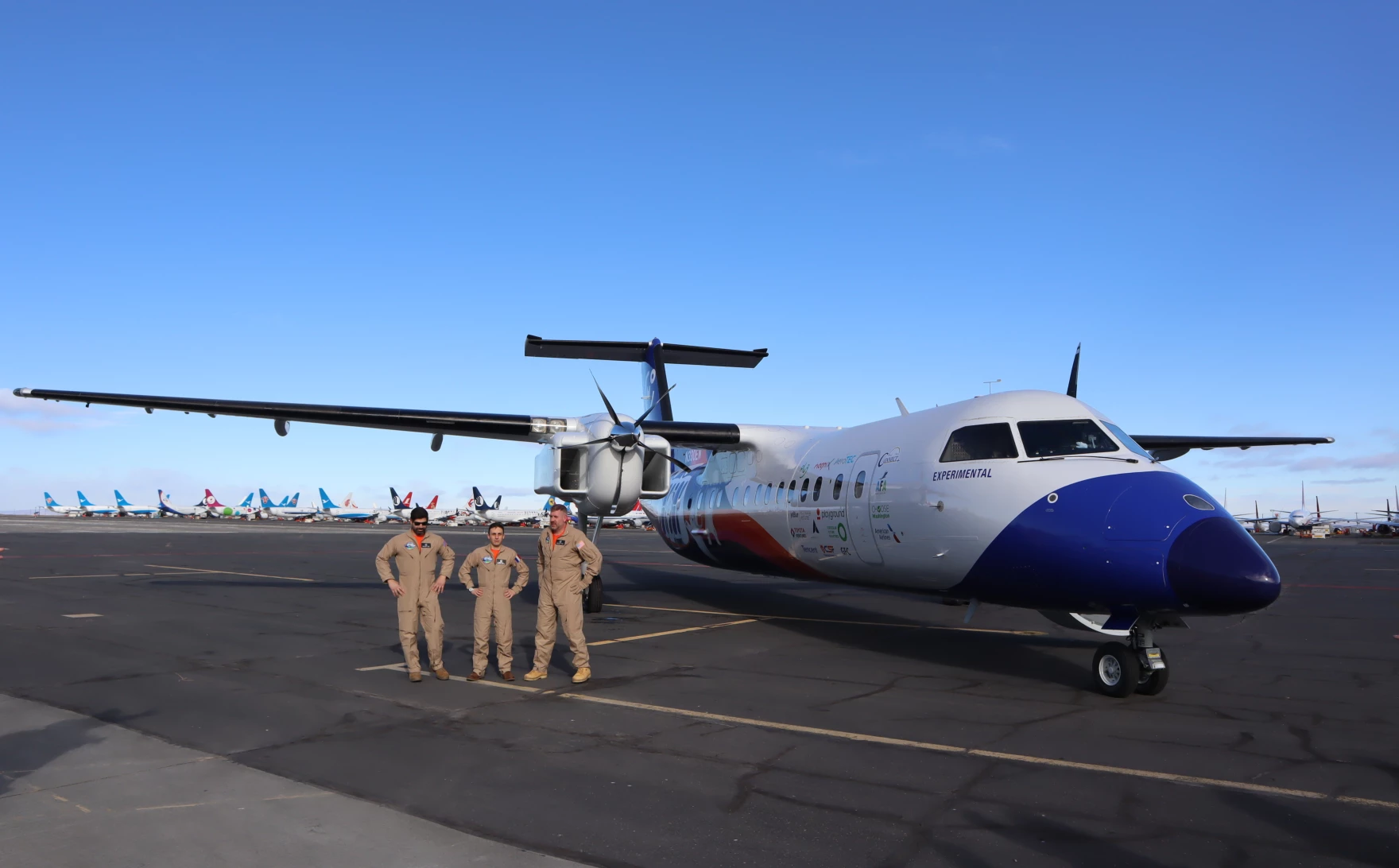 The Universal Hydrogen flight test crew posed for pictures after a successful first flight of the company's hydrogen-electric Dash 8 airliner on March 2, 2023
