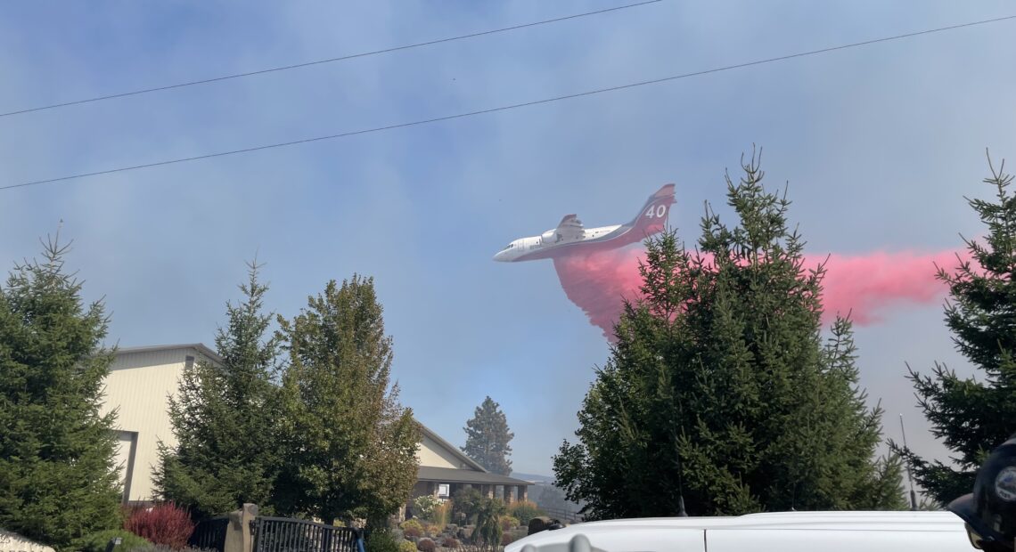 Aerial firefighting crews drop fire retardant on a fire outside of Spokane in 2022. Photo by Jay Wilkins.