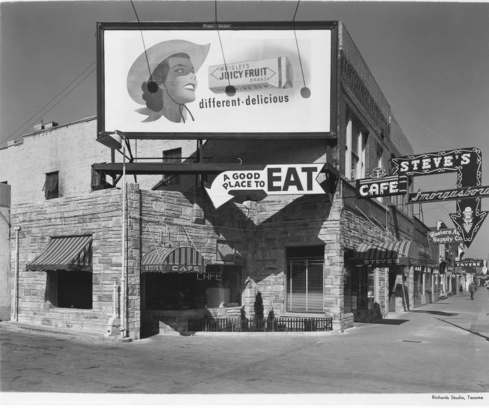The exterior of Steve's Cafe, later commonly known as Steve's Gay '90s, as it appeared in April of 1951. The real-life dining and entertainment hot spot is a setting in the historical fiction novel, The Farewell Tour. Photo courtesy of Northwest Room at The Tacoma Public Library, Richards Studio A57331-36.
