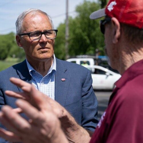 Washington Governor Jay Inslee speaking outdoors with the Mayor of Malden, Ted Maxwell.