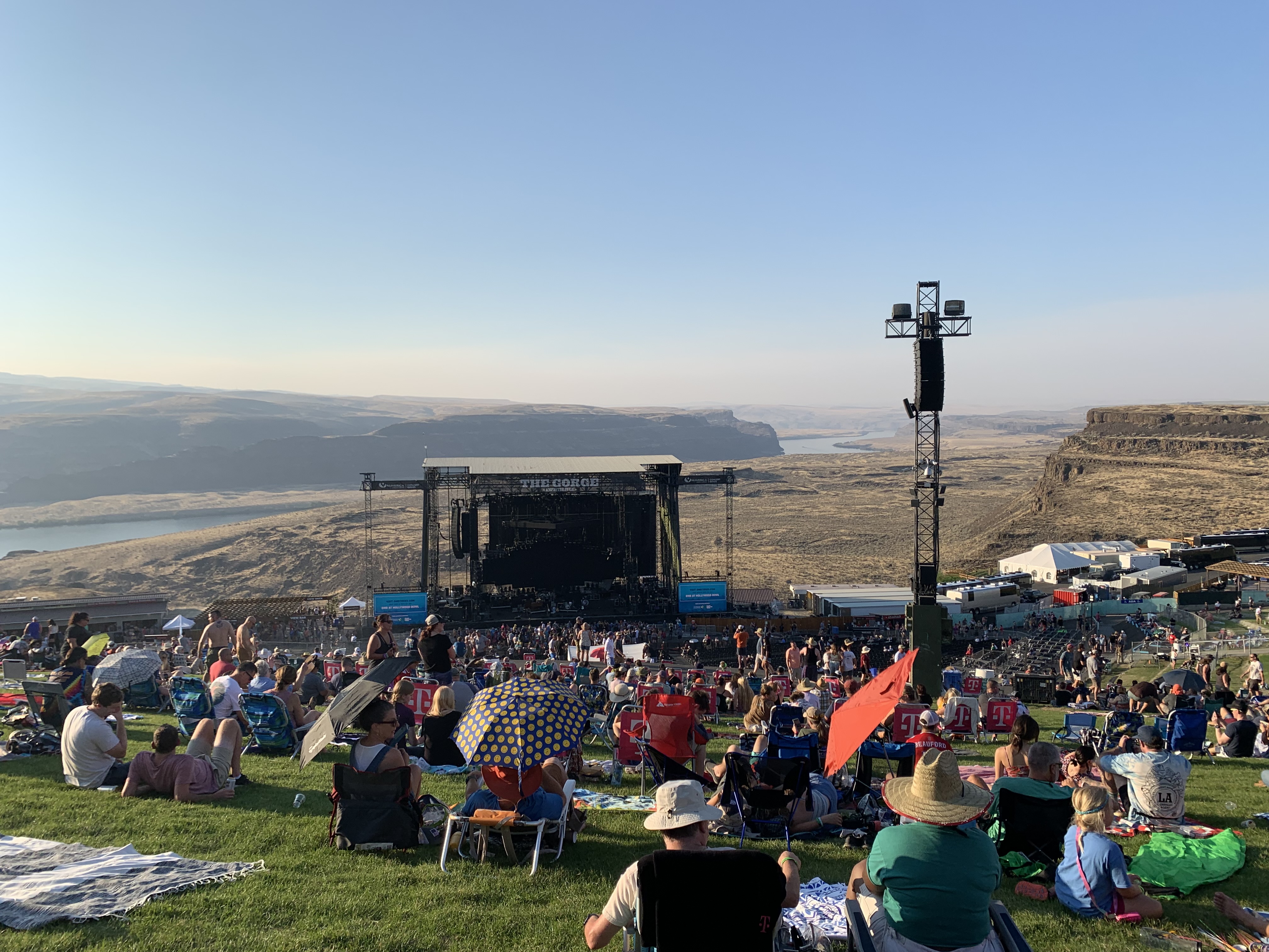 Near sunset at the Gorge Amphitheater, the Columbia River rolls at the back hip of the mainstage, while Dave Matthews plays last summer 
