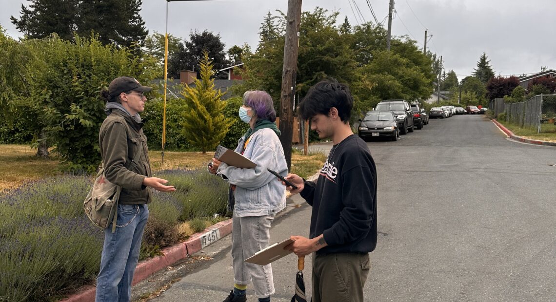 Zev Cook, far left, prepares canvassing volunteers in South Tacoma on Friday, June 9. Photo by Lauren Gallup.