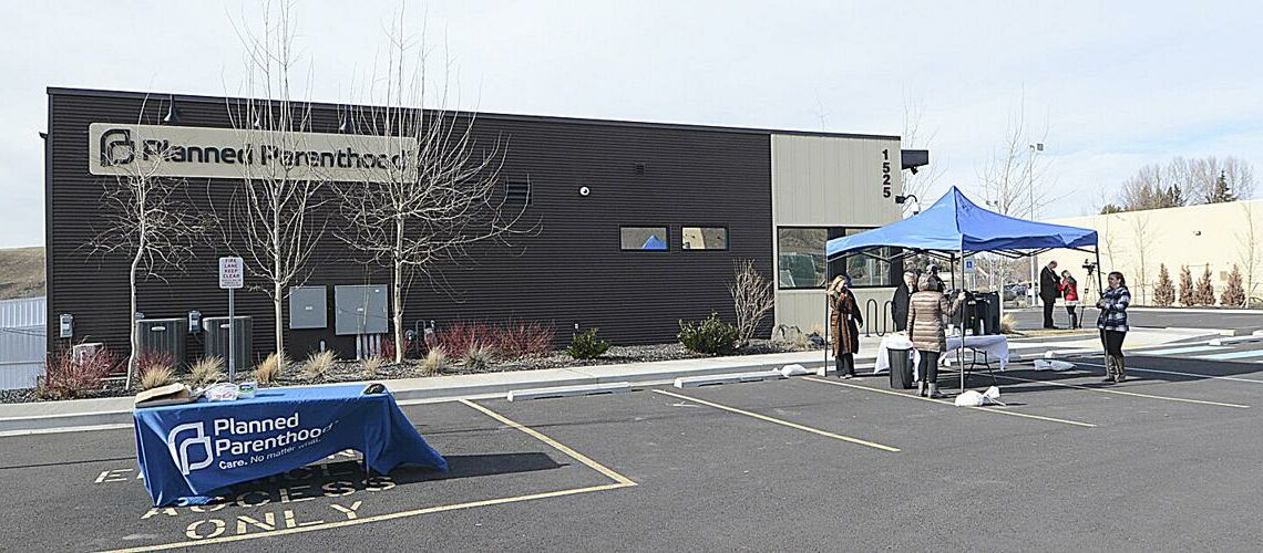 People stand outside the Pullman Planned Parenthood building during 2016. The clinic has seen an increase in patients from Idaho seeking abortions in recent months, following the passage of laws that have curtailed abortion in Idaho. (Credit: The Lewiston Tribune)