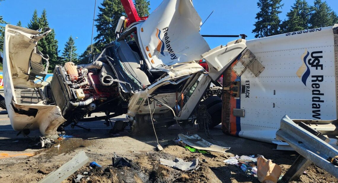 A crane had to be used to life the semi-truck, which was heavy with cargo. // Credit: WSDOT Tacoma, @wsdot_tacoma on Twitter