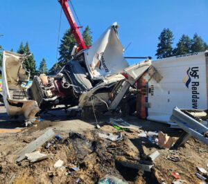 A crane had to be used to life the semi-truck, which was heavy with cargo. // Credit: WSDOT Tacoma, @wsdot_tacoma on Twitter