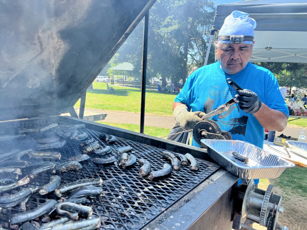 Yakama Nation member Evans Lewis grills lamprey. (Credit: Courtney Flatt.)