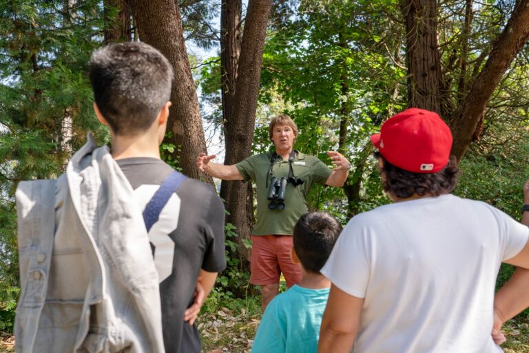 A man guides young people on a park tour