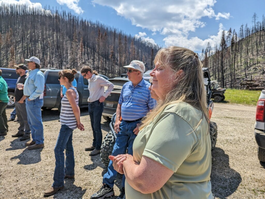 Robyn Smith stands near a group of people in Orogrande. 