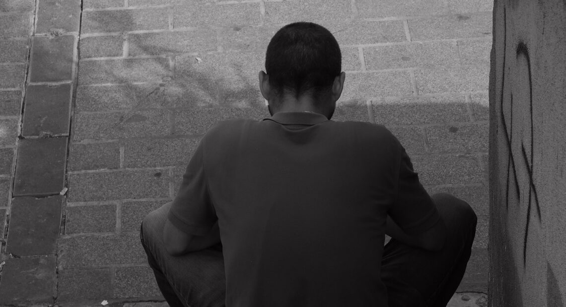 Man in Black Long Sleeve Shirt Sitting on Concrete Bench. (Credit: Özkan Keklik Pexels / Pexels).