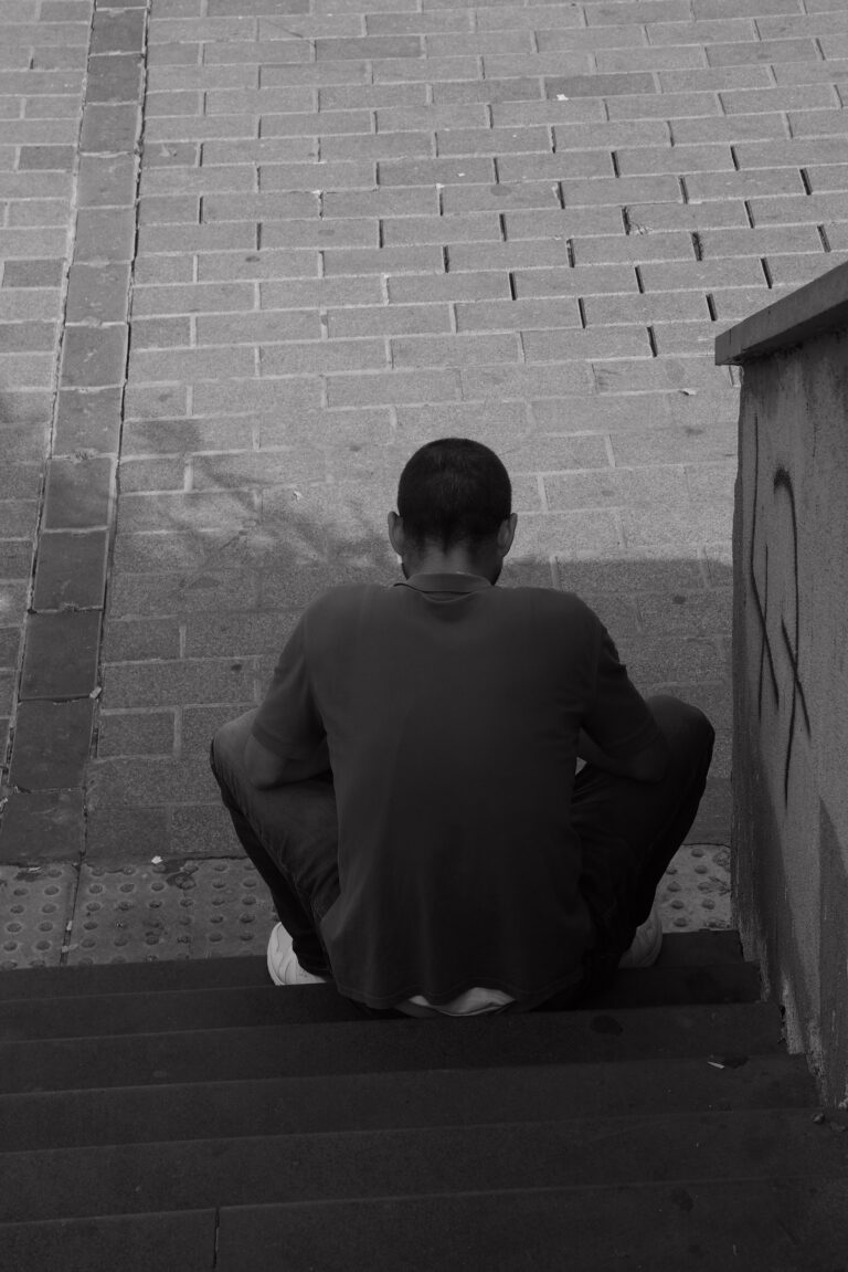 Man in Black Long Sleeve Shirt Sitting on Concrete Bench. (Credit: Özkan Keklik Pexels / Pexels).