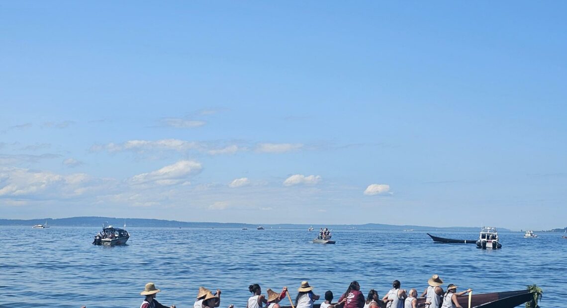 A canoe family paddles onto shore at Alki Beach Sunday, July 30. // CREDIT: Tracci Dial, NWPB
