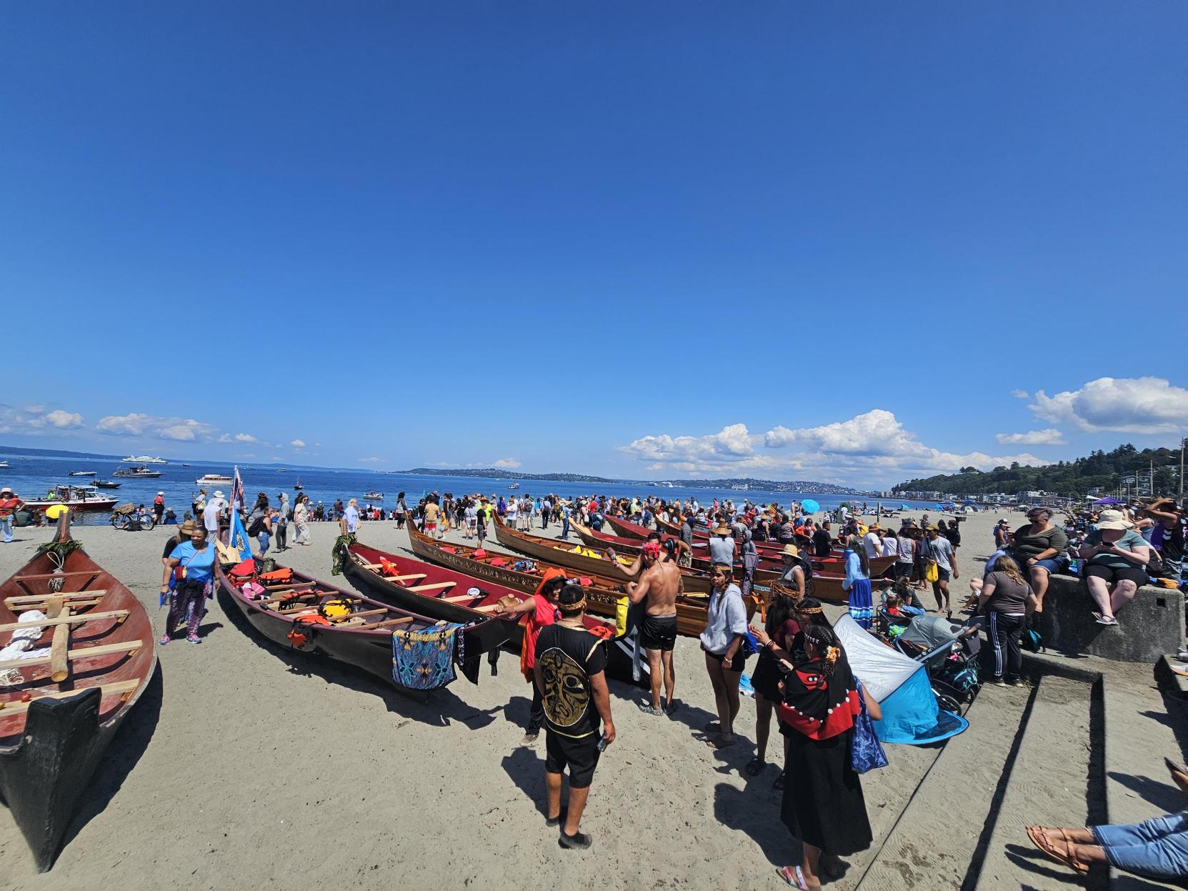 The canoes were brought up the sandy beach, where they laid safely as their passengers rested and ate in the hot sun. // CREDIT: Tracci Dial, NWPB