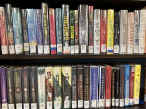 A close up shot of lots of young adult books line that a bookshelf in a library.