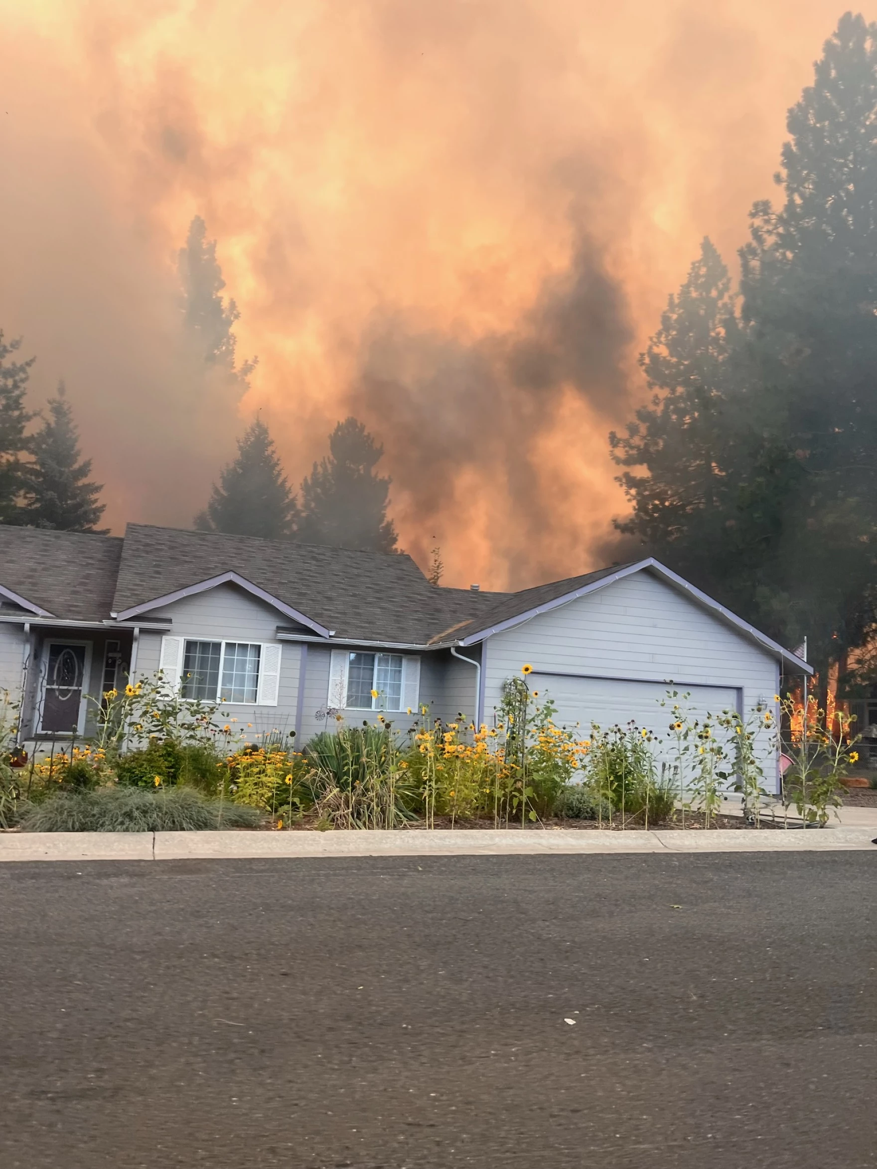 Sadie Rison, of Medical Lake, snapped this photo of her home and the Gray Fire on her way out of her neighborhood. Her home later burned down