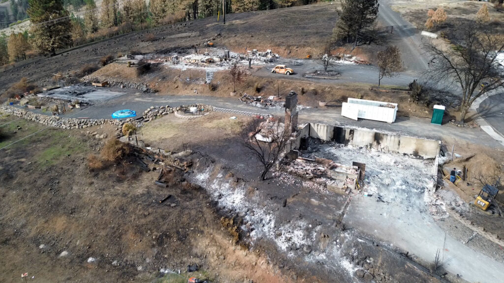 A bird's eye view shows multiple house sites turned to rubble in Wixson Heights.