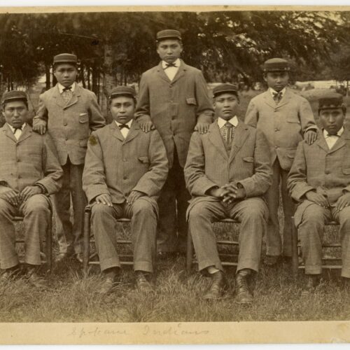 This historical photo, provided to Oregon Public Broadcasting by Pacific University archivist Eva Guggemos, shows seven boys who came to the Forest Grove Indian Training School from the Spokane tribe in 1880. The Forest Grove school operated for a few years before being relocated to Salem and renamed Chemawa Indian School.