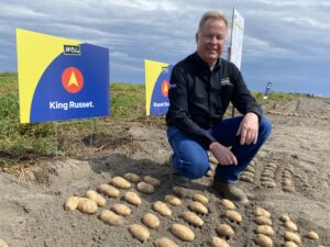 Ken Luke, a manager with McCain Foods, shows off some of the old standby potato varieties, along with some of the new, like the fresh “King Russet,” at a recent field day in Quincy.