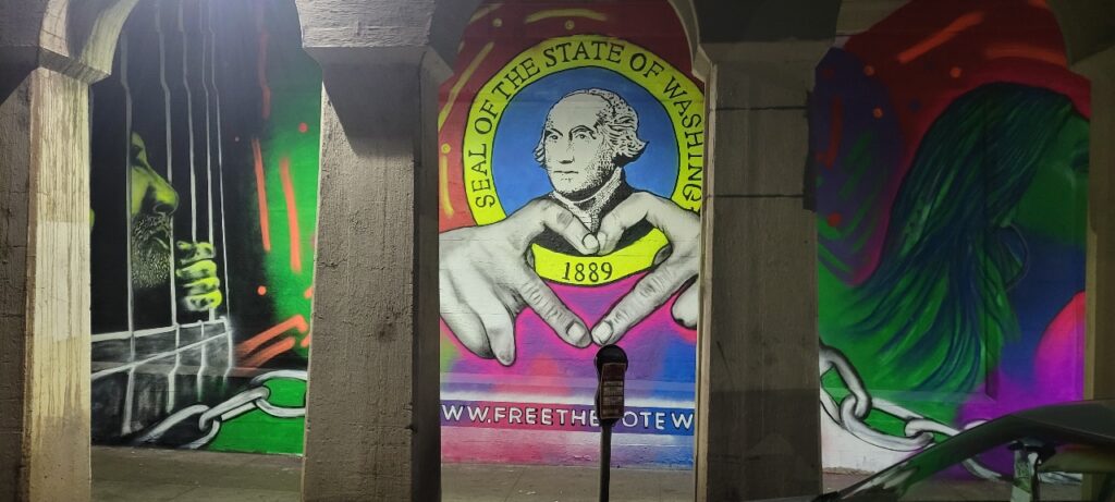 A mural painted in an underpass shows George Washington making a heart sign with his hands. 