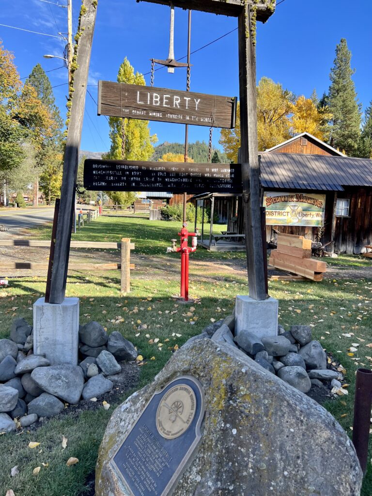 An old wooden sigh that's difficult to read -- it says "Liberty: The oldest mining townsite in the state."