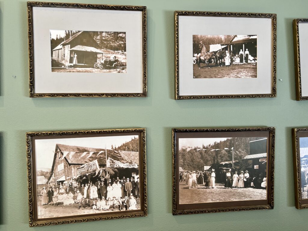 Two rows of framed sepia-toned pictures hang on a mint green wall.
