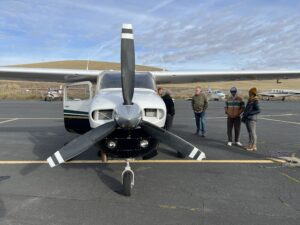 Passengers wait to board a plane for a tour with EcoFlight and Trout Unlimited. (Credit: Courtney Flatt, Northwest News Network)