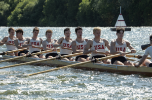 Image from the movie, Boys in the Boat, showing the team rowing.