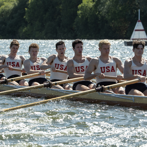 Image from the movie, Boys in the Boat, showing the team rowing.