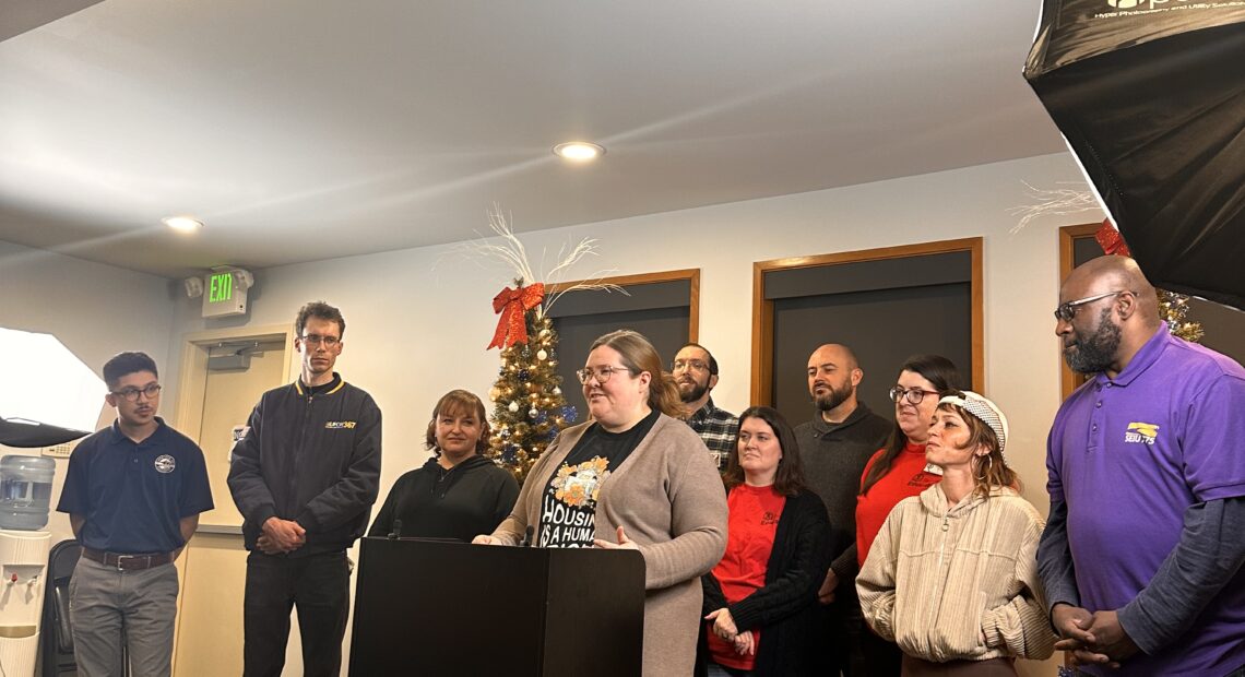 Tacoma labor leaders celebrate the passage of Citizens’ Initiative Measure No. 1 at a press conference on Friday, Dec. 8. (Credit: Lauren Gallup / NWPB)