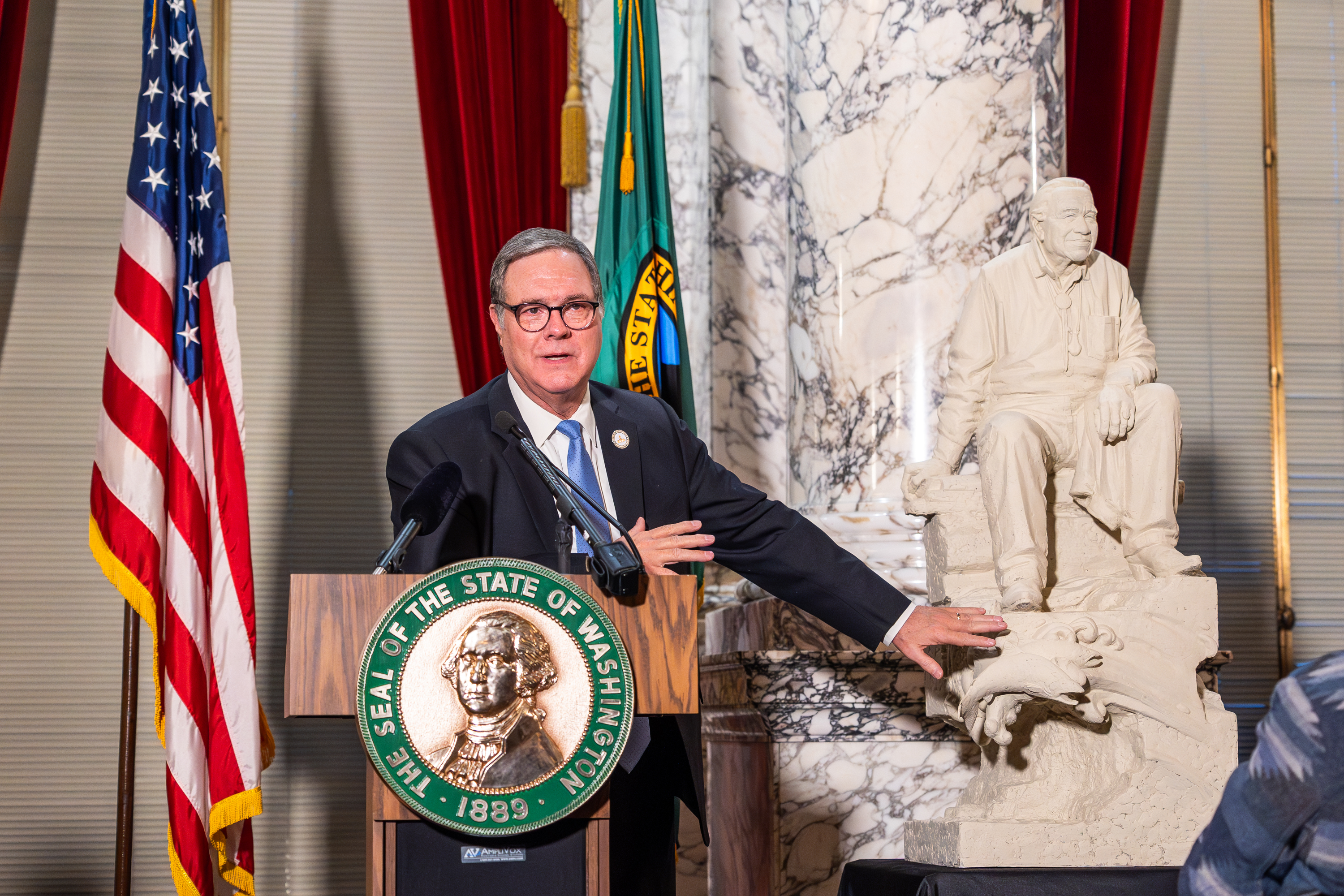 Lt. Gov. Denny Heck gestures toward the maquette of Billy Frank Jr., Jan. 10. 2024. (COURTESY: WA Leg Photography)