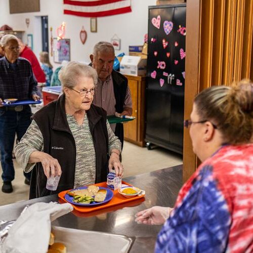Karon Schlieber, left, of Lewiston, picks up her lunch from Site Manager Chrystal Wiese on Jan. 26, 2023 at the Valley Community Center in Clarkston. (Credit: Austin Johnson / Lewiston Tribune)