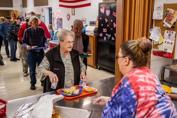 Karon Schlieber, left, of Lewiston, picks up her lunch from Site Manager Chrystal Wiese on Jan. 26, 2023 at the Valley Community Center in Clarkston. (Credit: Austin Johnson / Lewiston Tribune)