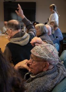 Participants raise their hands to speak, or sometimes, they interrupt each other, at the Port Angeles Senior and Community Center political discussion group. (Credit: Tela Moss / NWPB)