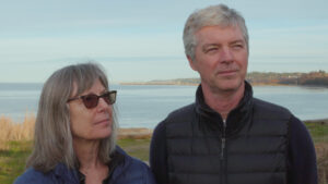Karen Chadwick, left, and John O'Dowd stop on their walk along the Port Angeles waterfront. The couple moved from San Francisco and enjoy the political diversity here. (Credit: Tela Moss / NWPB)