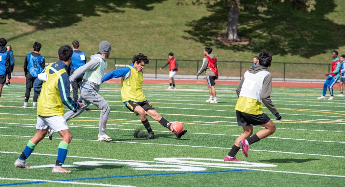 Junior Reyes (center) takes a shot on goal during tryouts for the Tri-Cities Badgers FC semi-pro soccer team March 2 at Fran Rish Stadium in Richland. (Credit: Annie Warren / NWPB)