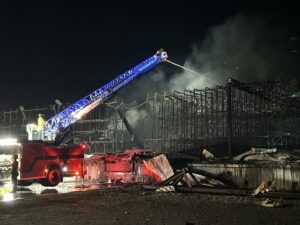 Fire crews spray water on rubble at the Lineage Logistics fire in Finley, Washington. The fire started on April 21. (Credit: Benton County Fire District 1)