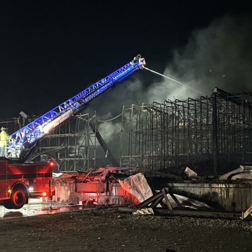 Fire crews spray water on rubble at the Lineage Logistics fire in Finley, Washington. The fire started on April 21. (Credit: Benton County Fire District 1)