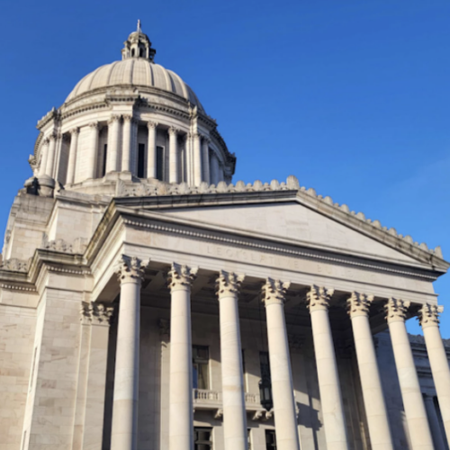 The Washington State Capitol building against a deep blue sky.