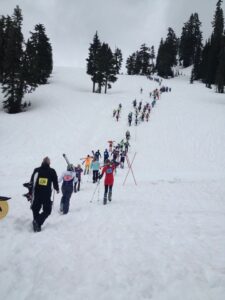 Downhill skiers climb up a hill before putting on their skis in the 2014 Ski to Sea race. (Credit: Courtney Flatt.)