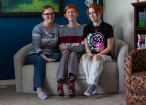 Jade Stellmon sits with her son, Hamilton Stellmon, and daughter, Tk, in their Moscow home on Friday. Hamilton Stellmon is currently taking a health class at Moscow High School where a guest speaker from the nonprofit Palouse Care Network was approved to provide guest lectures on sex ed. (Credit: Rachel Sun / NWPB)